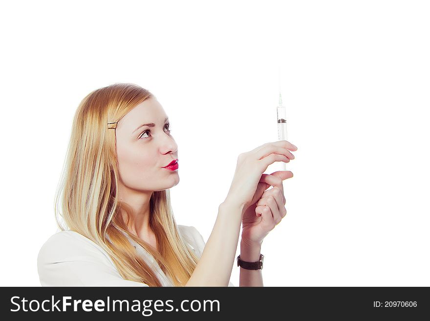 Pretty nurse with syringe in medical white uniform