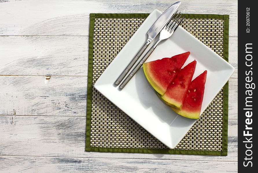 Melon slices on a white plate