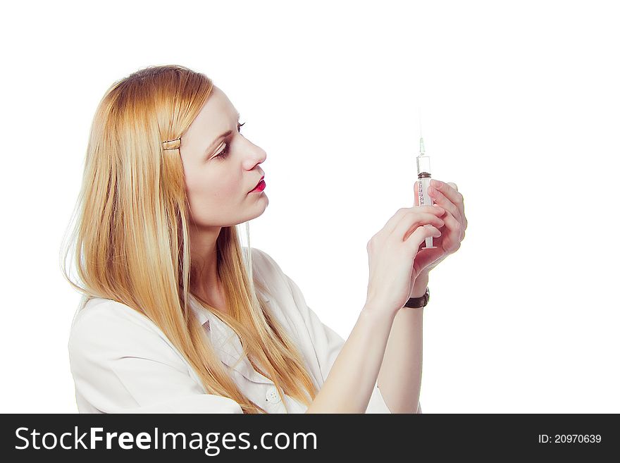 Pretty nurse with syringe in medical white uniform