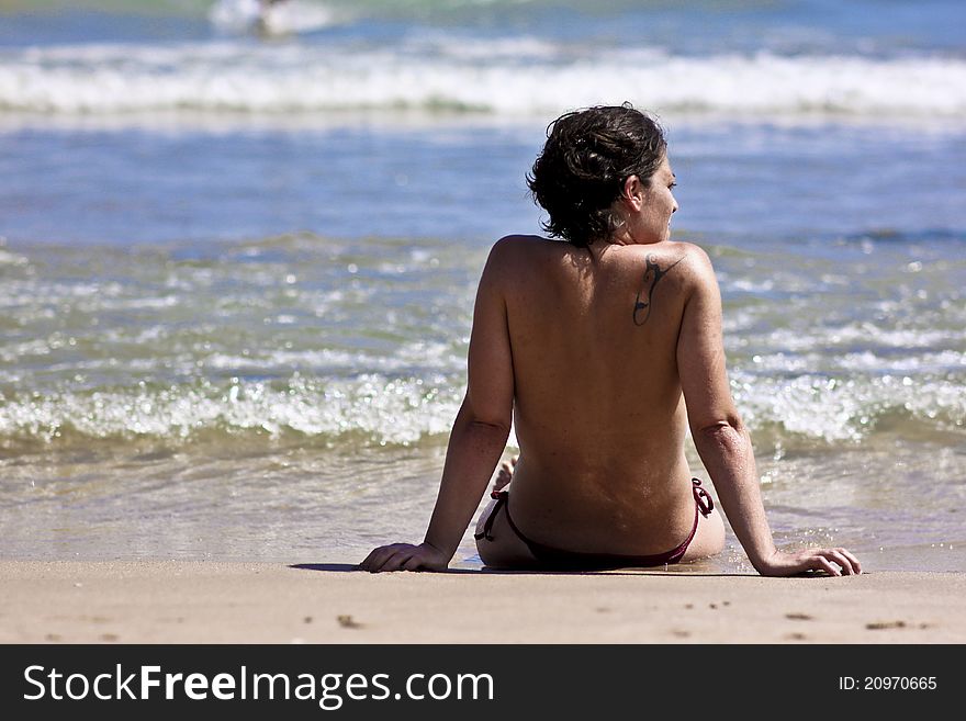 Woman on the beach taking sun