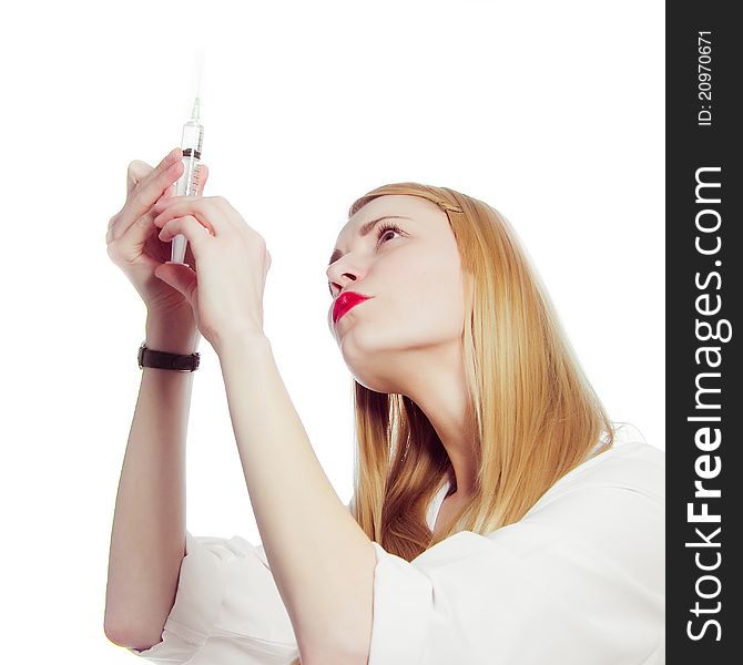 Pretty nurse with syringe in medical white uniform