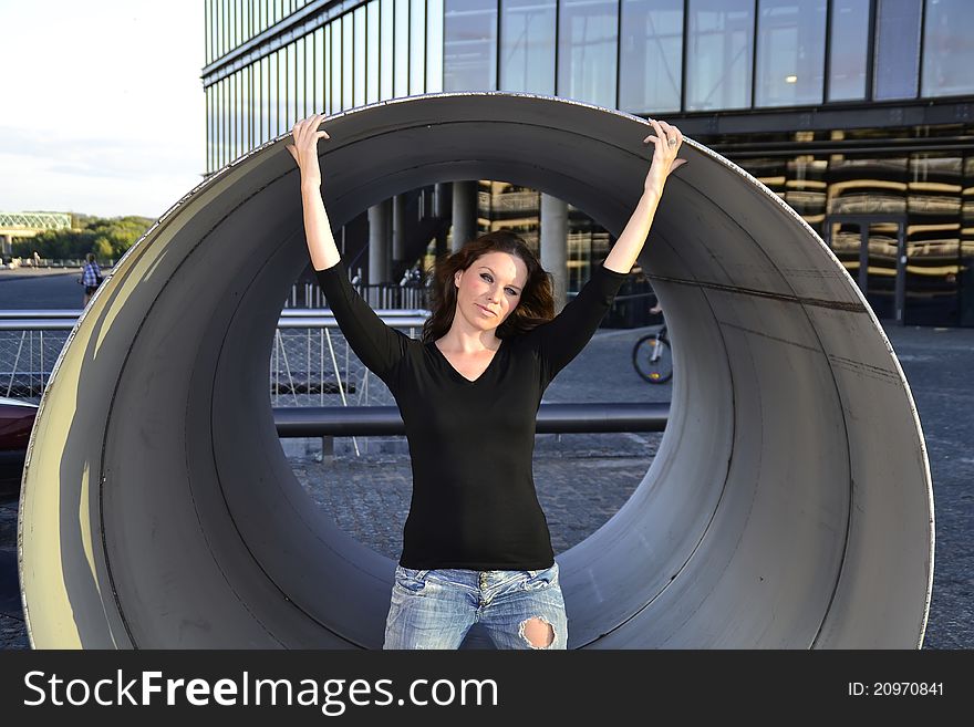 Girl standing inside the metallic pipe. Girl standing inside the metallic pipe