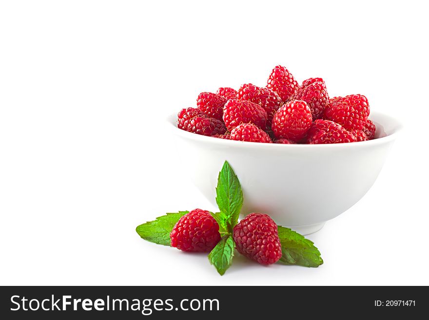 Raspberries in a white bowl on a white background. Raspberries in a white bowl on a white background