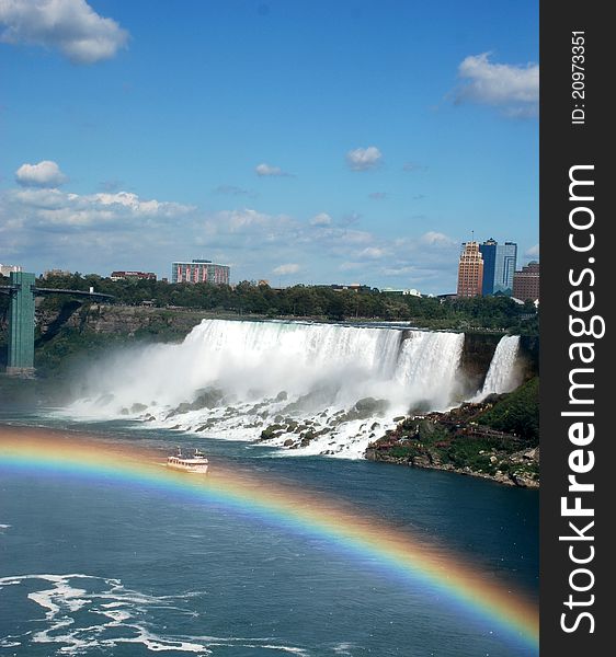 Boat is swimming across the rainbow on the Niagara Falls. Boat is swimming across the rainbow on the Niagara Falls