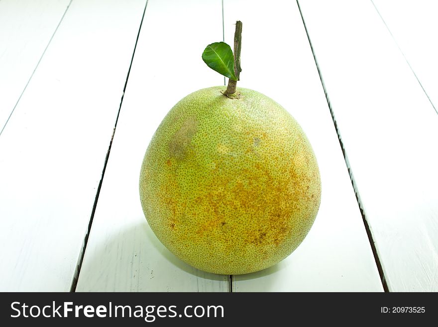 Green grapefruit on white table. Green grapefruit on white table