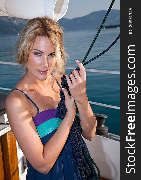 Pretty blond on the yacht holding rope. Pretty blond on the yacht holding rope