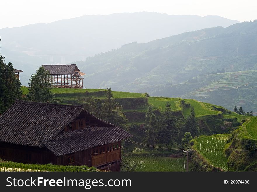 Wood building under construction on the hill at sunset. ZhaoXing Village architecture.