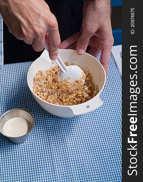 Mixing oatmeal and cream in a plastic bowl