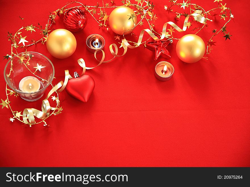 Golden bauble,candle lights and ribbon on red background. Golden bauble,candle lights and ribbon on red background.