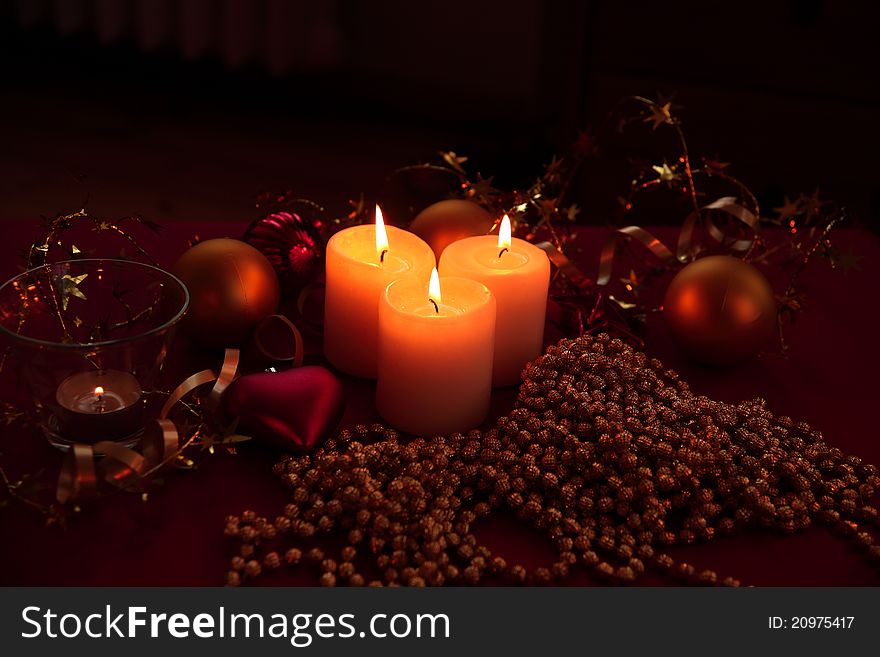 Candle lights, bauble and ribbon on red bakground. Candle lights, bauble and ribbon on red bakground.