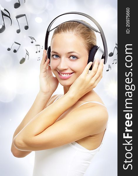 Girl listening to music on a light background