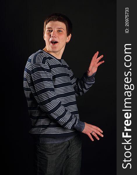 A young boy profile portrait on a black background