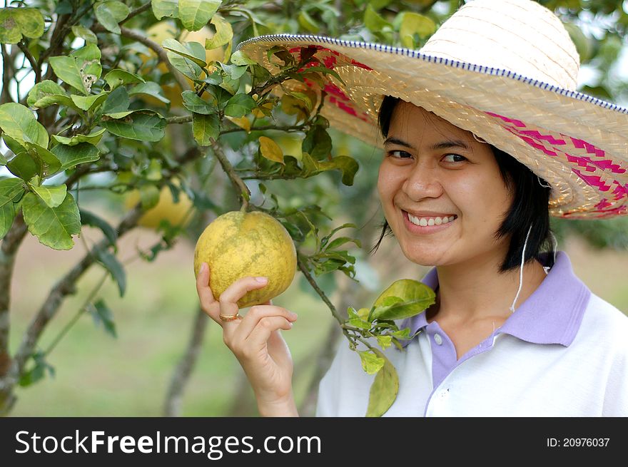 Portrait of gardener lady in a grapefruit garden