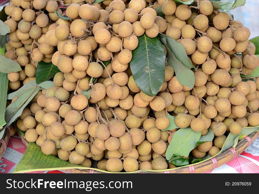 A bunch of longan sell in the market. A bunch of longan sell in the market