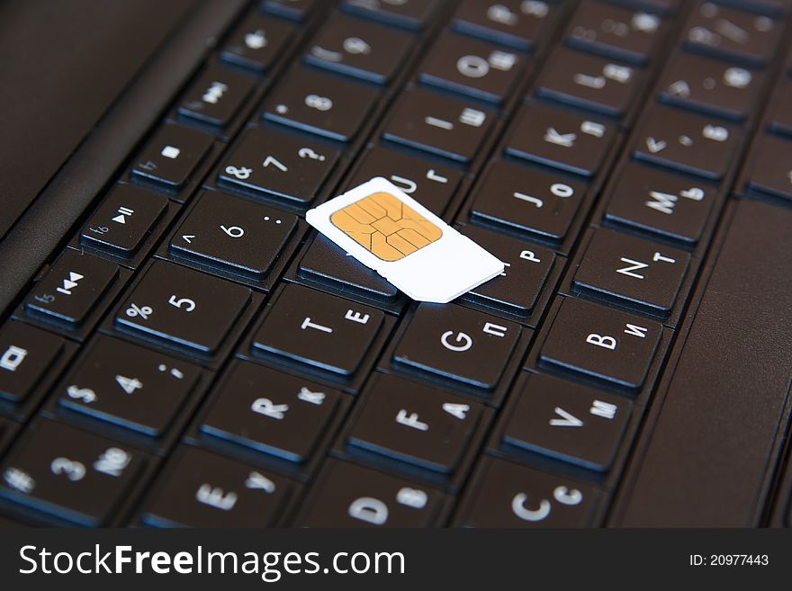 Telephone sim card on the laptop keyboard