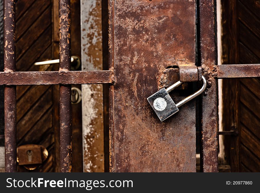 Old rusty padlock on cell door