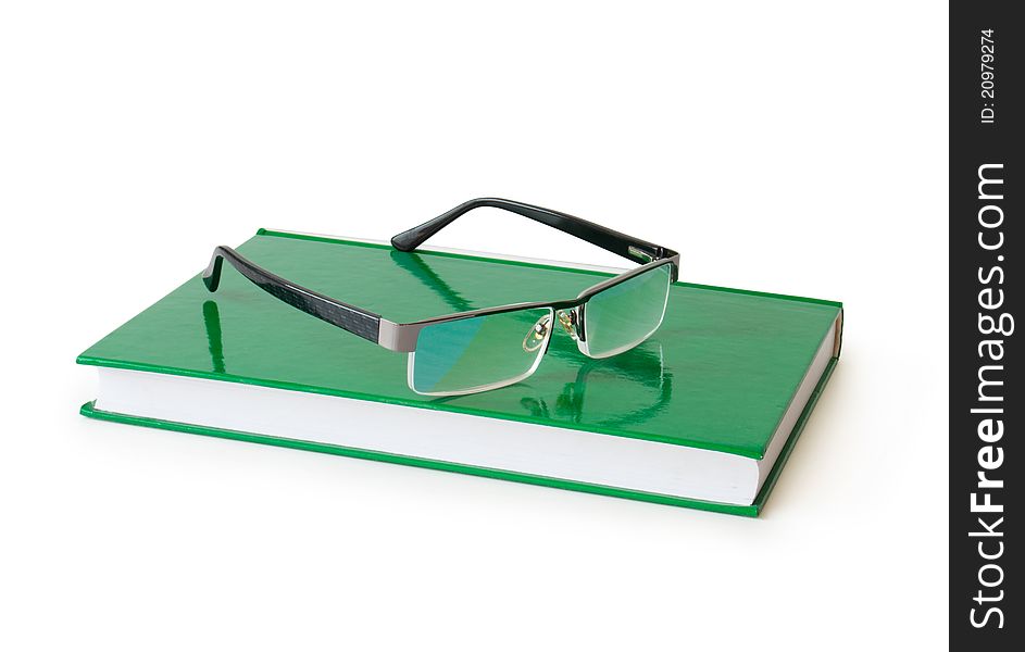 Book with eyeglasses on a white background