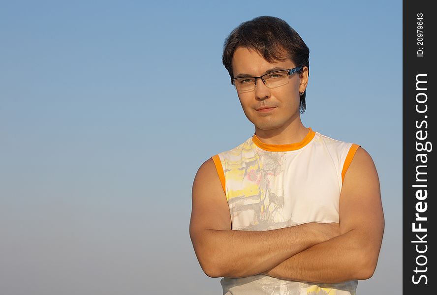 Portrait of a handsome young man with crossed hands. Portrait of a handsome young man with crossed hands