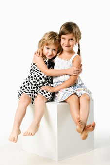 Two Little Girlfriends Sitting Together Isolated Royalty Free Stock Image