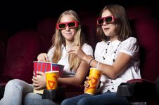 Two Beautiful Girls Watching A Movie At The Cinema Stock Photos Two Beautiful Girls Watching A Movie At The Cinema Stock Photos