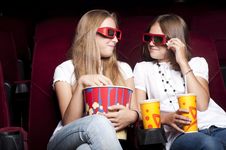 Two Beautiful Girls Watching A Movie At The Cinema Two Beautiful Girls Watching A Movie At The Cinema