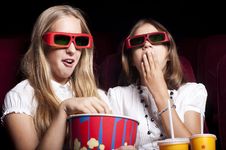 Two Beautiful Girls Watching A Movie At The Cinema Two Beautiful Girls Watching A Movie At The Cinema