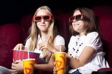 Two Beautiful Girls Watching A Movie At The Cinema Two Beautiful Girls Watching A Movie At The Cinema