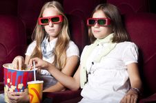 Two Beautiful Girls Watching A Movie At The Cinema Two Beautiful Girls Watching A Movie At The Cinema