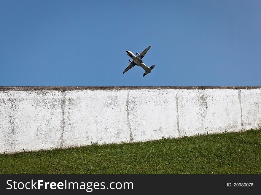 Military aircraft in training and doing a flyby next to a wall. Military aircraft in training and doing a flyby next to a wall.