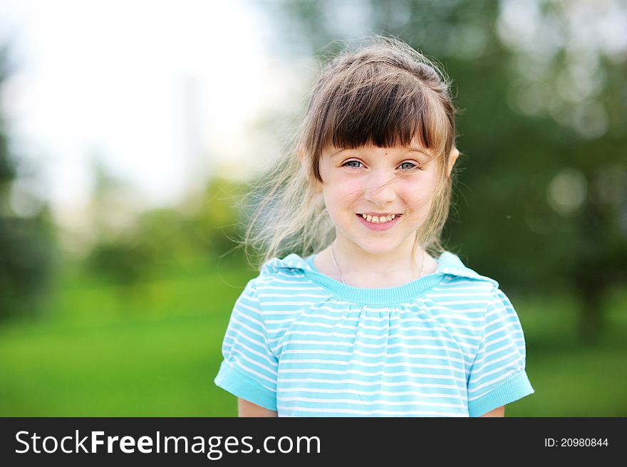 Outdoor portrait of adorable child girl in blue jacket. Outdoor portrait of adorable child girl in blue jacket