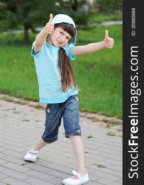 Outdoor Portrait Of Cute Child Girl In Blue Jacket