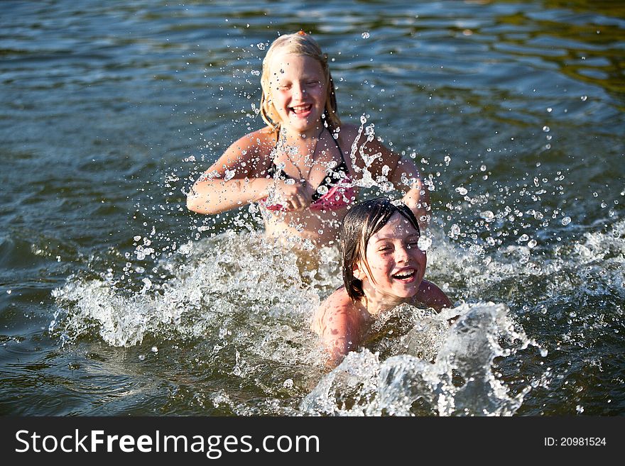 Two kids play in wather, splashing. Two kids play in wather, splashing.