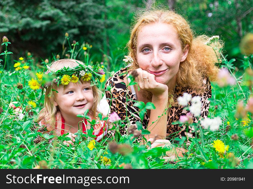 Beautiful girl with mother in the meadow