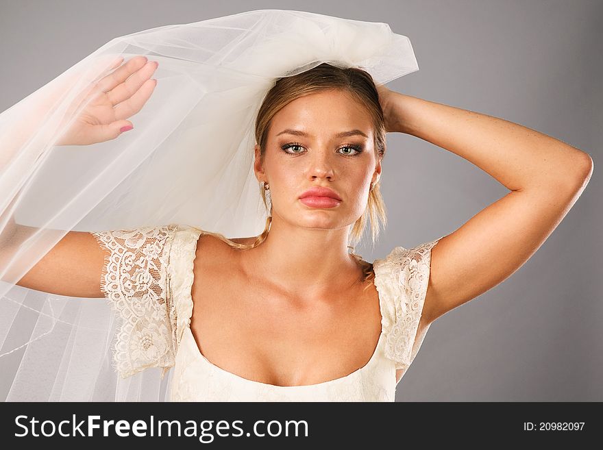 Excited Bride Earing A Veil In Studio