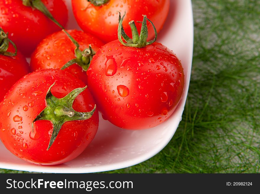 Fresh tomatoes with waterdrops in a bowl. Fresh tomatoes with waterdrops in a bowl