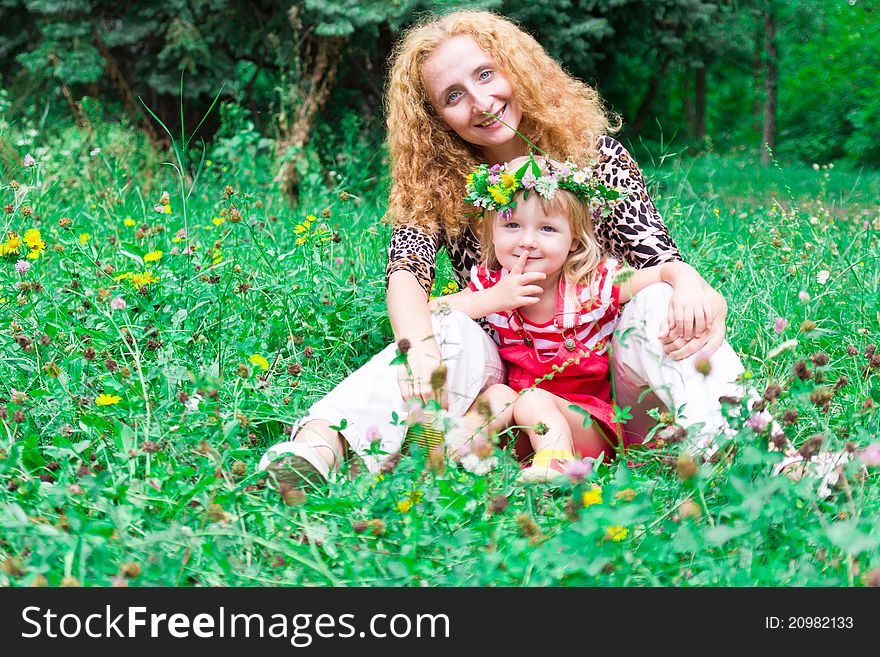Beautiful girl with mother in the meadow