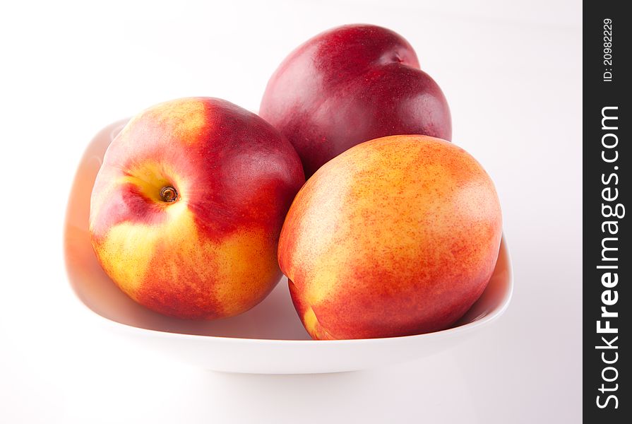 Three Peaches On A Plate