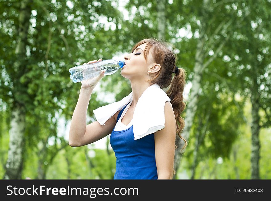 Young Woman Drinking Water After Exercise