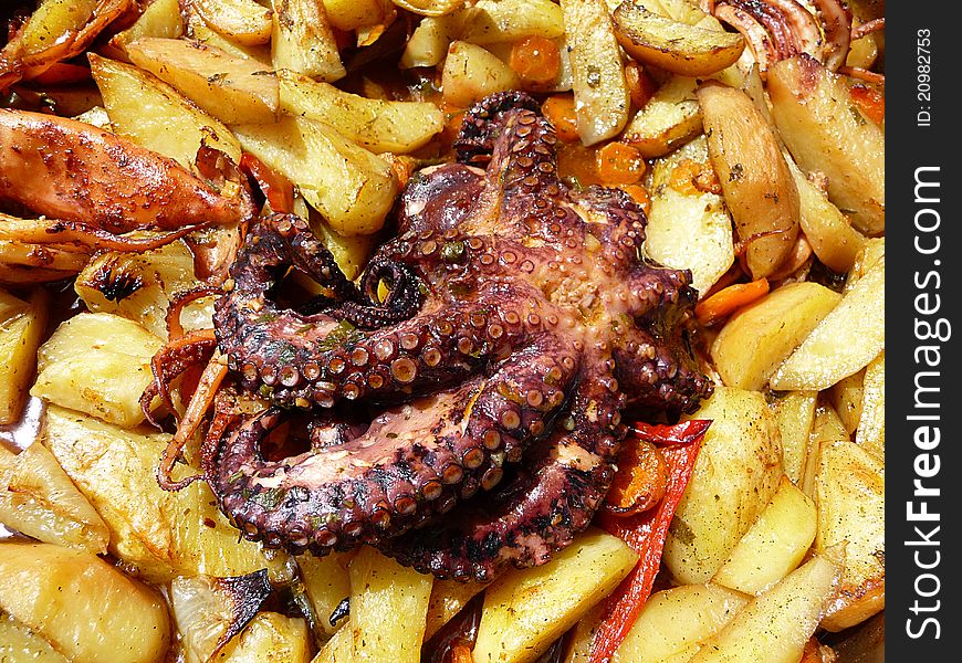 Octopussy with potato baked in olive oil - traditional Dalmatian dish
