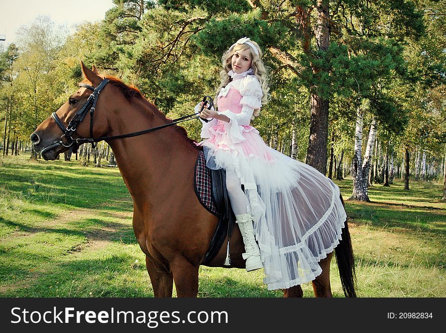 Model on a horse in the summer wood. Model on a horse in the summer wood