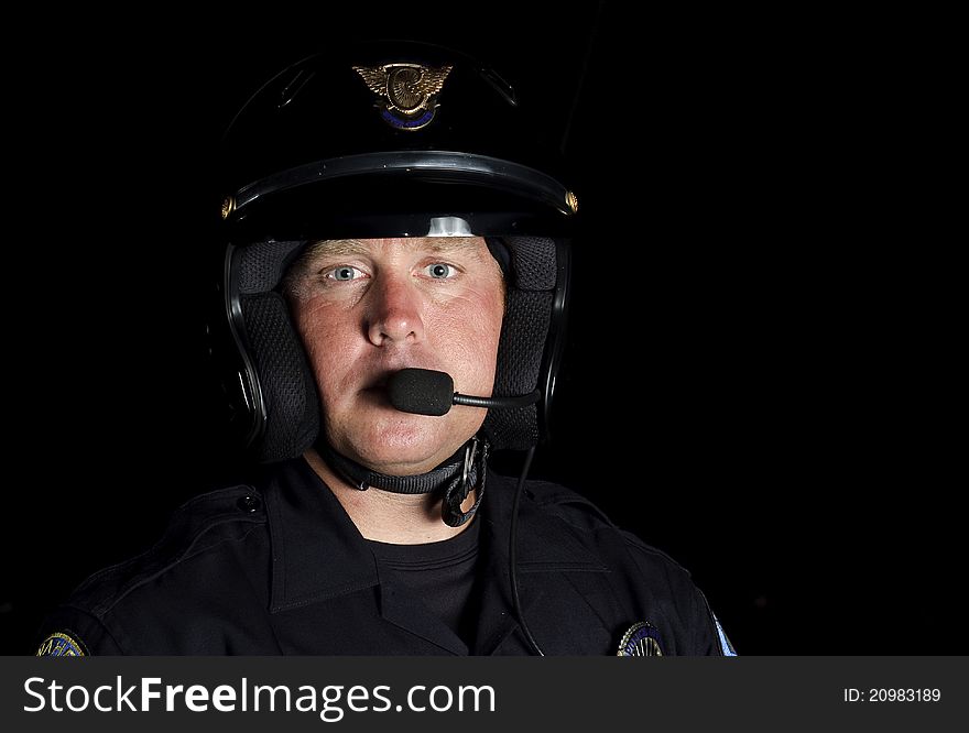 A police motorcycle officer in the night. A police motorcycle officer in the night.