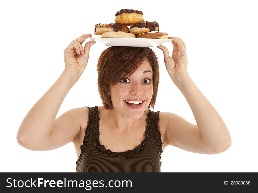 A woman excited about the pile of doughnuts she has on her head. A woman excited about the pile of doughnuts she has on her head.