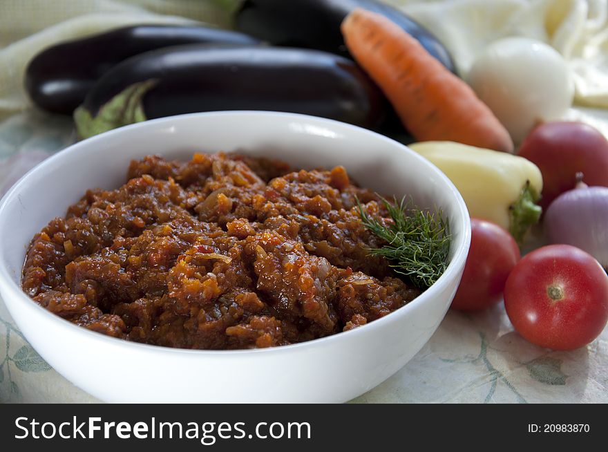 Close up of the eggplant caviar and and its components: eggplant, tomatoes, onions, carrots, peppers. Close up of the eggplant caviar and and its components: eggplant, tomatoes, onions, carrots, peppers.