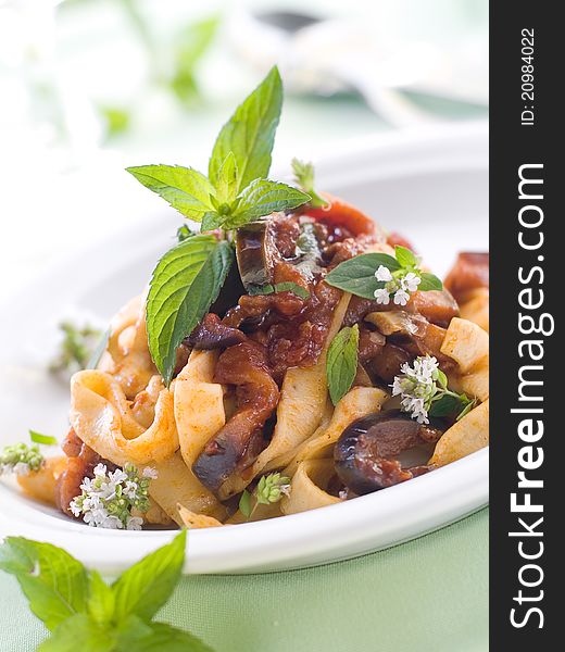 Tagliatelle with zucchini and tomato sauce and mint. Selective focus