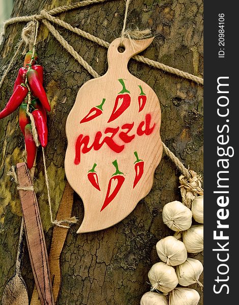 Wooden board on the tree with pizza word