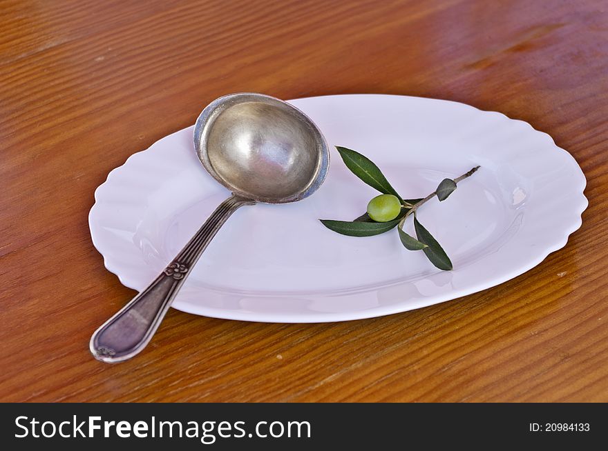 Olive branch with olives on a wooden background