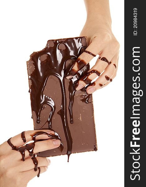A woman holding on to a big candy bar with her hands and candy bar covered in chocolate syrup. A woman holding on to a big candy bar with her hands and candy bar covered in chocolate syrup.
