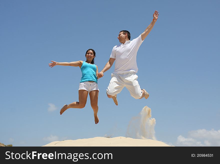 Young Man And Woman Jumping