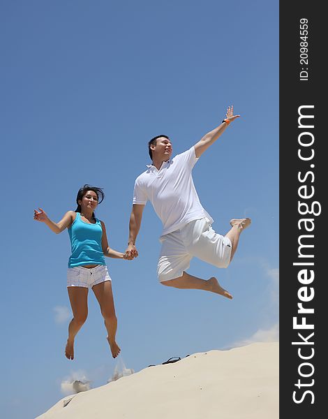 Young Man And Woman Jumping