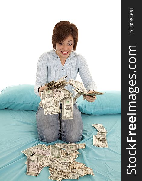 A woman looking at all her money in her hands and bed. A woman looking at all her money in her hands and bed.